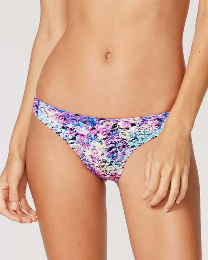 Tide + Seek Sustainable swimwear model wearing Purple Lava Cheeky Coverage Bikini Bottom front view