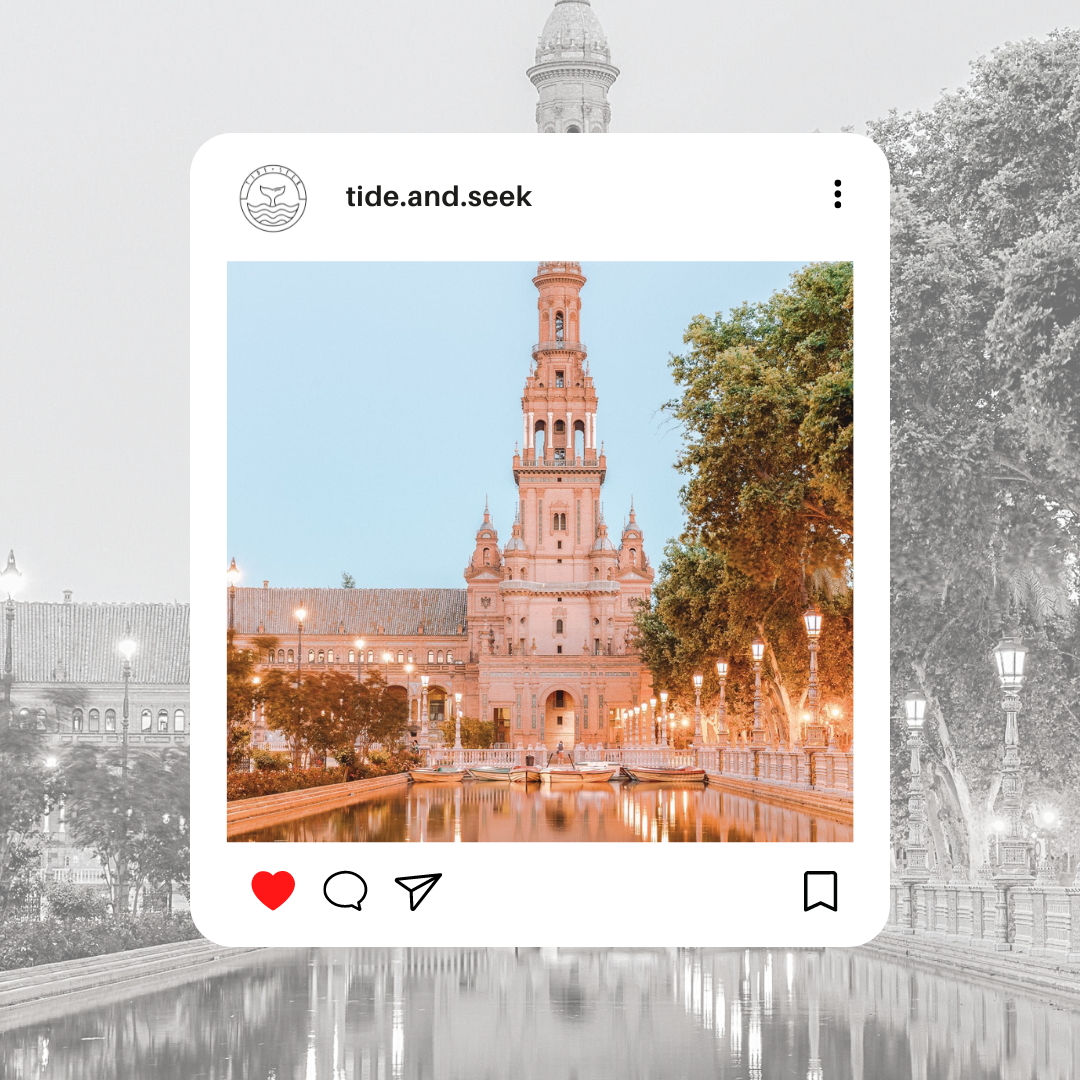 Tide and Seek sustainable swimwear travel blog post about budget friendly holidays for winter sun - image of a grand building in Seville, Spain with large fountain reflecting street lamps of the surface water