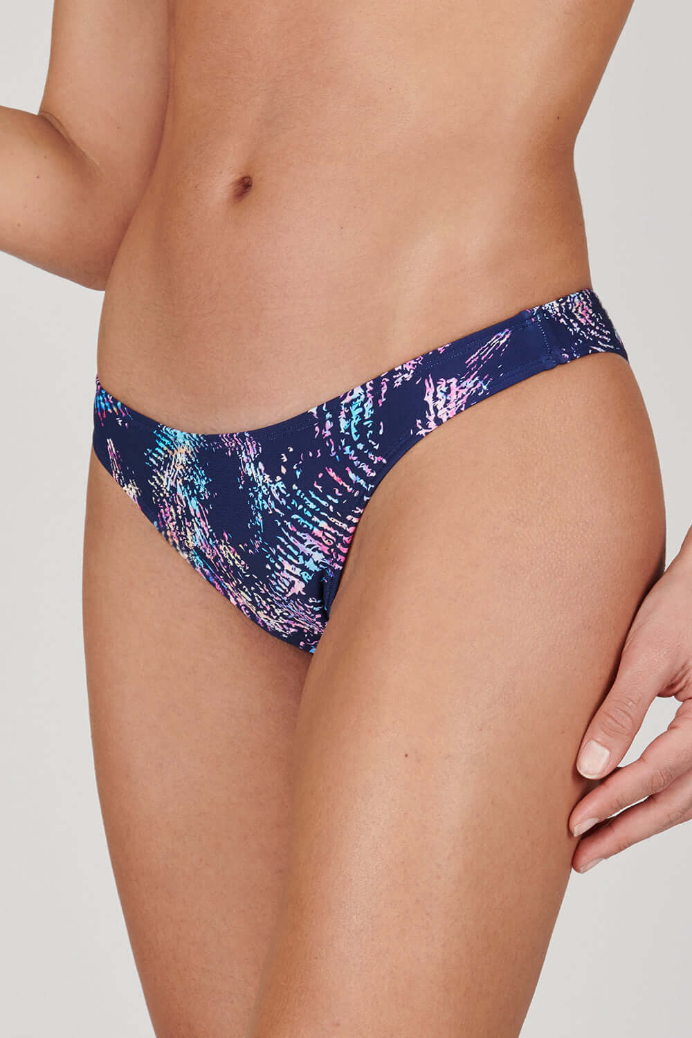 Tide + Seek Sustainable swimwear model wearing Tropic Rave Cheeky Coverage Bikini Bottom