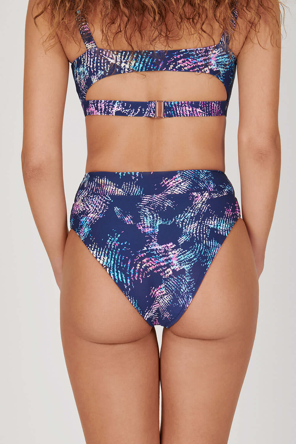 Tide + Seek Sustainable swimwear model wearing Tropic Rave Fitness Bikini Top and High Waisted Bikini Bottoms