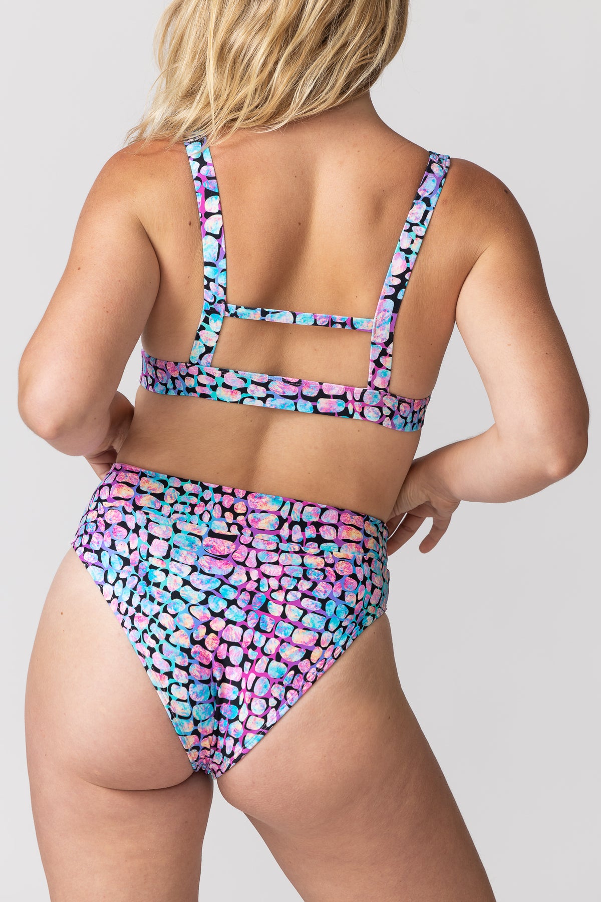 Tide and Seek sustainable swimwear high waisted bikini bottoms on model also wearing triangle plunge bikin top  top