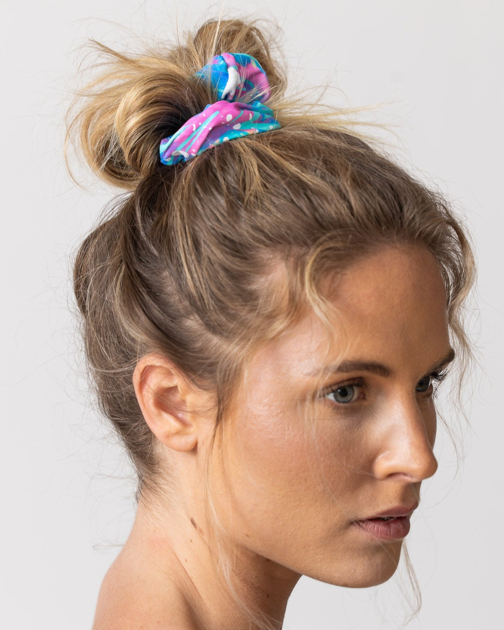 Tide and Seek sustainable swimwear blonde model wearing cosmic bolt pink and blue handmade scrunchie